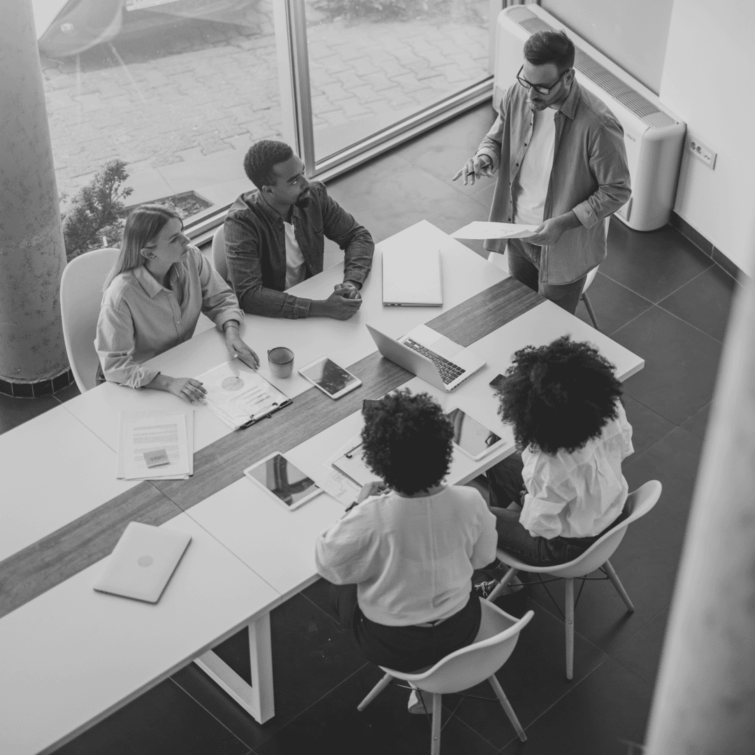 Colleagues discussing work around table