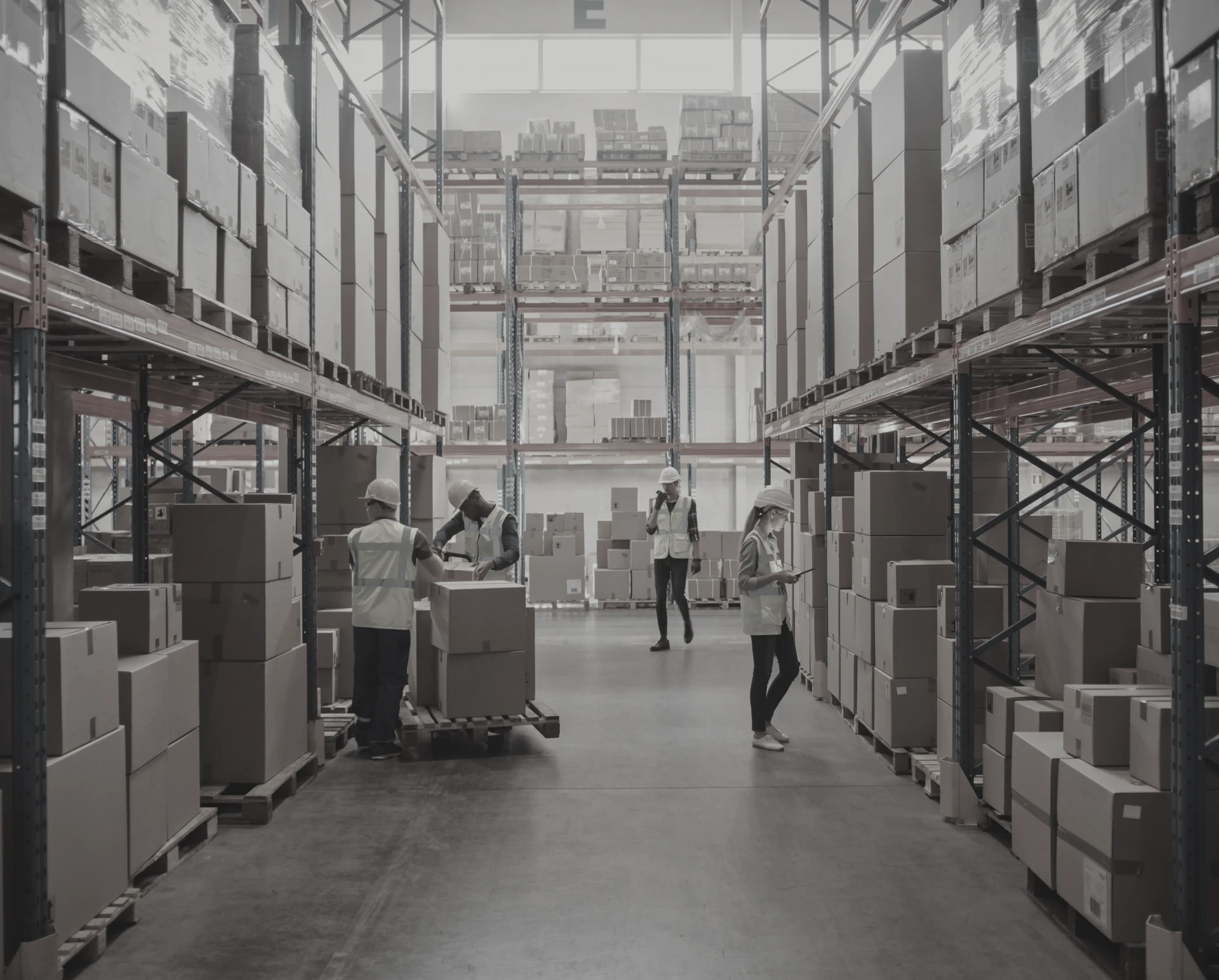 Warehouse workers organizing boxes on shelves